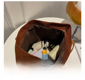 Top view of faux suede tote bag showing large interior capacity with daily essentials