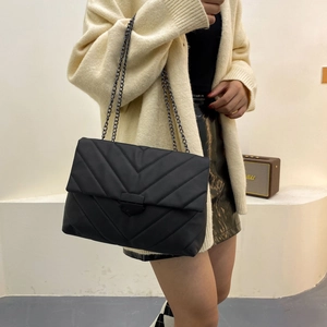 Chic black V-quilted shoulder bag with gunmetal chain strap and flap closure