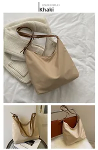 Vues détaillées du sac d'épaule en nylon kaki avec anses en cuir marron et design spacieux
