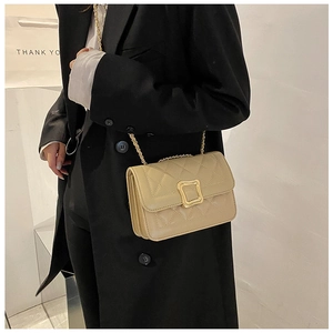 Quilted flap crossbody bag in beige leather with golden chain strap and buckle detail