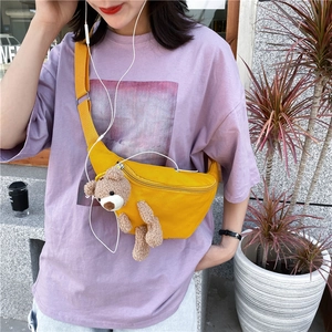 Vibrant yellow canvas chest bag with a 3D plush bear mascot on a purple t-shirt