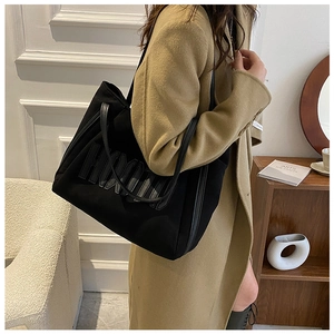 Detail shot of black faux suede tote bag with large embossed HOODIE letters