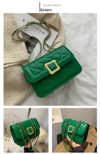 Detail of green quilted crossbody bag with gold square buckle and leather chain strap