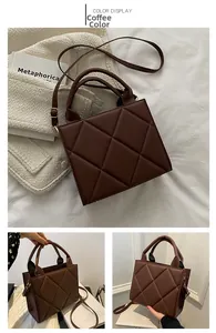 Close-up of coffee brown quilted crossbody bag with metal hardware and round handles