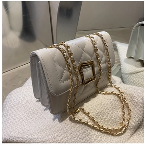 Close-up of quilted white leather bag with square gold buckle and chain strap