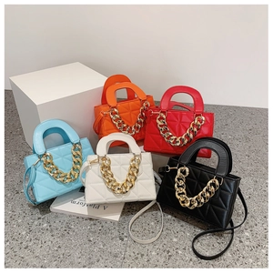Detailed view of quilted crossbody bags with chunky gold chains in five vibrant colors