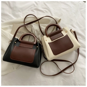 Detail view of stylish color-block crossbody bags in black, beige, and brown PU leather