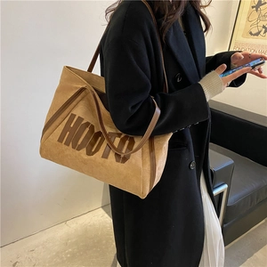 Brown suede tote bag with HOOTO lettering and leather handles in a retro style