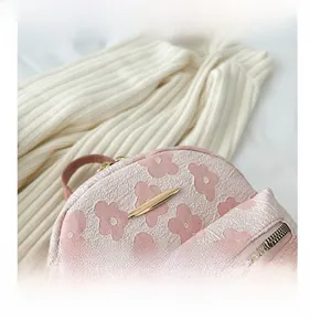 Détail du tissu floral rose avec fermeture éclair dorée et garnitures métalliques de qualité