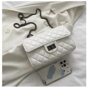 Detailed size comparison of white quilted leather flap bag next to a smartphone