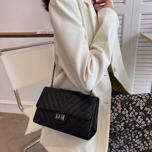Chic black V-quilted crossbody bag with metallic chain strap and twist-lock closure