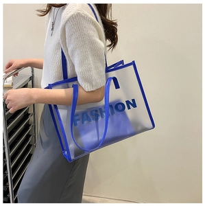 Detail of transparent PVC tote bag with blue trim and fashion lettering in a large size