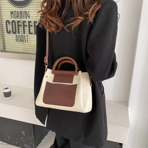 Minimalist cream and dark brown contrast handbag styled with a black blazer