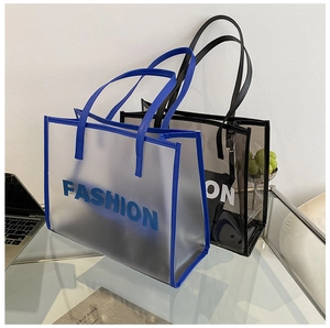 Detail view of transparent PVC tote bags featuring large fashion letter print and sturdy straps