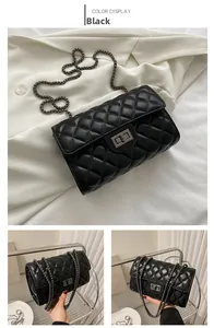 Detail of black quilted chain bag featuring rectangular gunmetal lock and PU leather texture