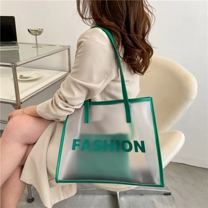 Transparent green jelly tote bag with leather trim and inner pouch shown from a side view