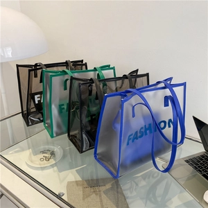 Minimalist transparent jelly tote bag with FASHION lettering in blue green and black colors
