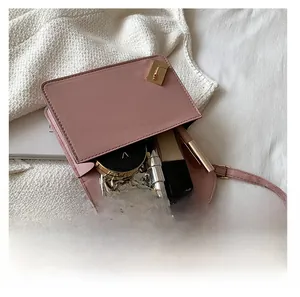 Top view of open pink crossbody bag showing capacity for phone and cosmetics