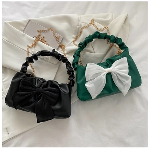 Detail of the elegant oversized organza bow and gathered handle on these stylish fashion handbags