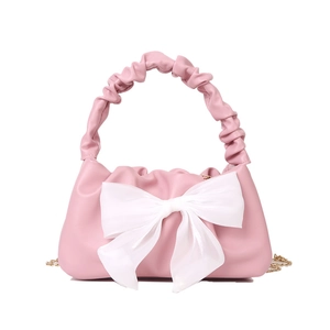 Pink ruched cloud bag for women with a large white bow and golden metal chain strap