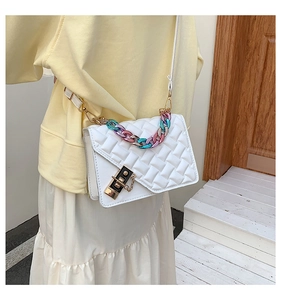 White quilted leather handbag featuring a colorful resin chain handle and metal lock detail