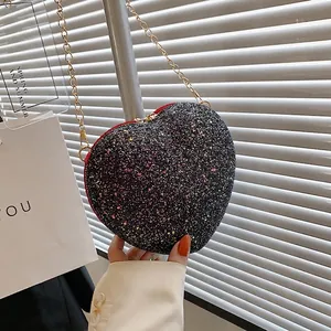 Sparkly heart-shaped crossbody bag with pink sequins and gold chain strap for women