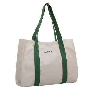 Minimalist canvas tote bag with forest green straps and fashion print in front view