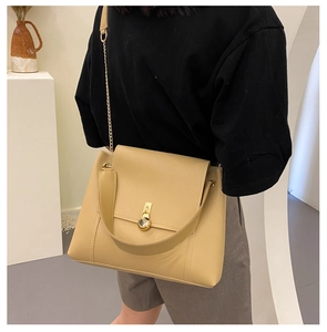 Detailed view of khaki crossbody tote bag with golden metal chain and round buckle strap