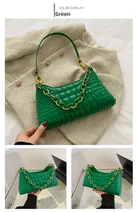 Detail of green baguette bag with quilted checkerboard texture and chunky metal chain
