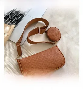 Brown embossed PU leather underarm bag featuring a mini round coin purse and wide strap