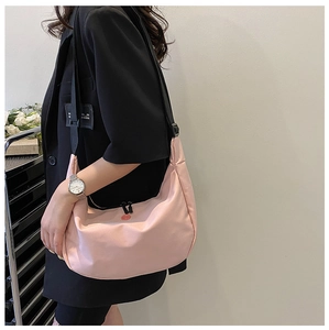 Detail of pink crescent crossbody bag in oxford cloth with adjustable black strap
