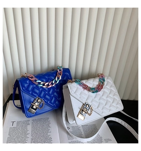 Detail of blue and white quilted crossbody bags with gradient chunky chain handles