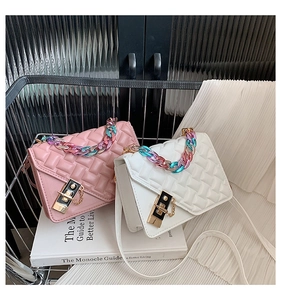 Detail of quilted mini bags with colorful gradient chains and metallic twist locks