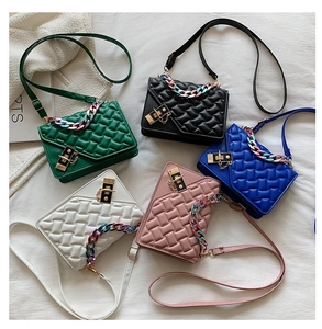 Detail of five colorful quilted bags with gradient acrylic chains and gold locks