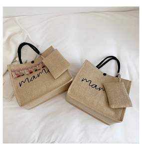 Detail of linen tote bag featuring mama print, rope handles and colorful tassel charm