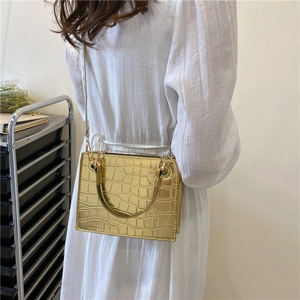 Golden crocodile embossed crossbody bag with metallic chain strap for stylish women