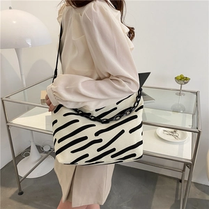 Minimalist canvas tote bag with hand-drawn black stripes and stylish chain detail