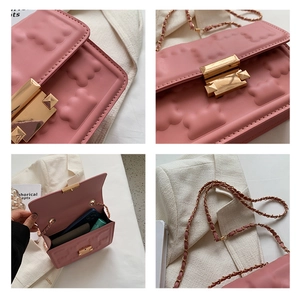 Close-up of pink chain bag showing embossed bear texture and gold metallic clasp