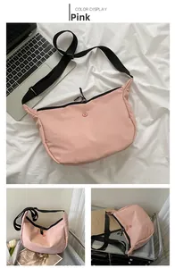 Pink nylon crescent crossbody bag with adjustable strap and spacious capacity