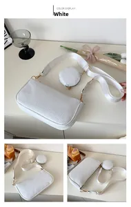 Detail of white textured underarm bag with a detachable round coin purse and woven strap