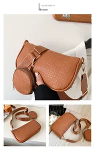 Close-up of brown woven shoulder bag with detachable round coin purse and gold hardware
