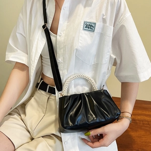 Minimalist black pleated cloud bag with pearl handle and leather shoulder strap