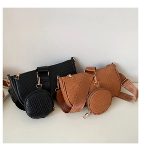 Detail of vintage embossed underarm bag with gold zipper and detachable coin purse accessory