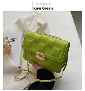 Detail of kiwi green quilted square bag with gold chain strap and metal clasp closure