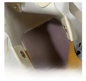 Detail view of thickened bottom and color-block interior with golden magnetic closure