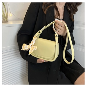 Light yellow flap square bag with checkered scarf detail on handle and long shoulder strap