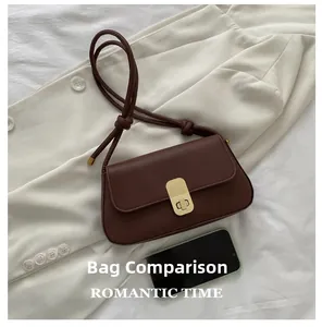 Detailed comparison showing brown minimalist handbag size next to a smartphone