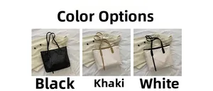 Three large tote bags in black, khaki and white with embossed monogram texture
