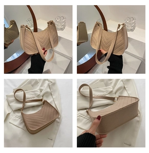 Macro details of beige crescent shoulder bag with V-shaped quilting and wool-like texture