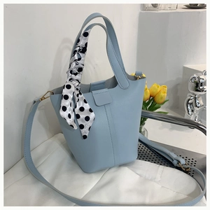 Light blue bucket bag in pebble PU leather with a polka dot silk scarf detail